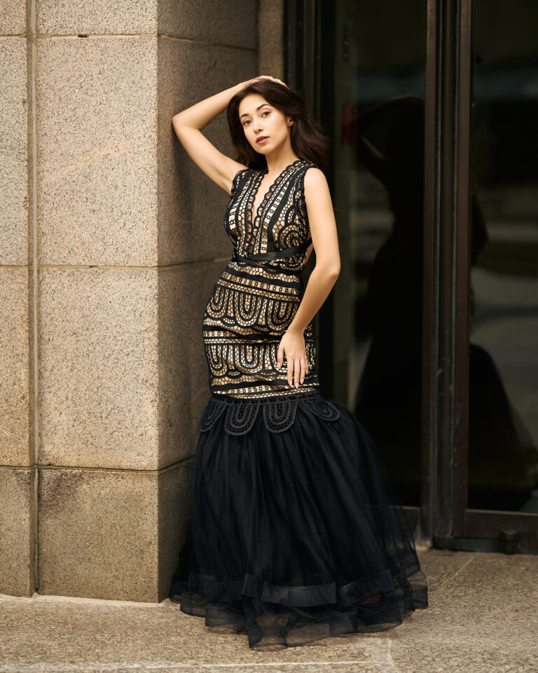 Model wearing black dress in city photoshoot