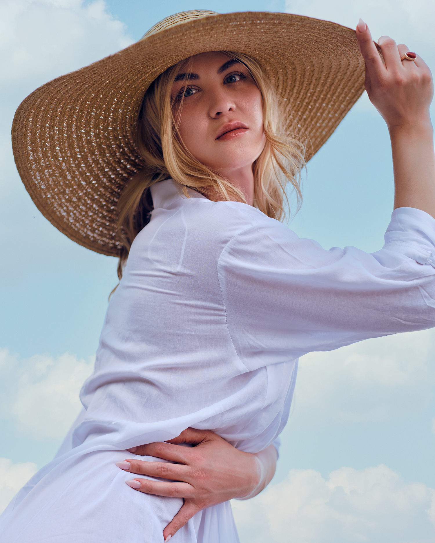 girl wearing white shirt and beach hat